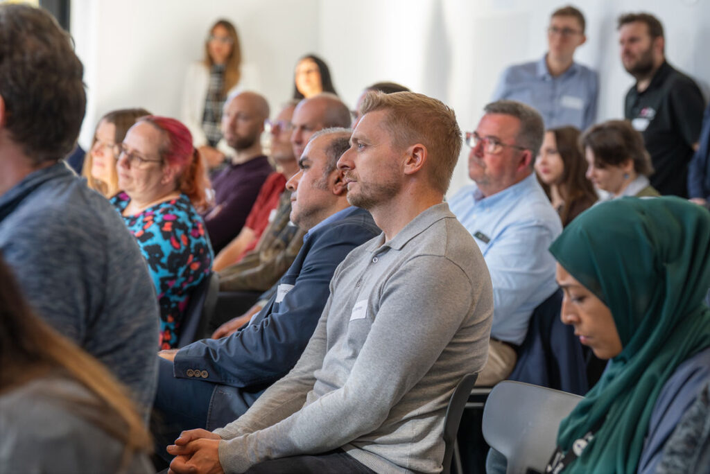 A seated audience at a regional cyber session