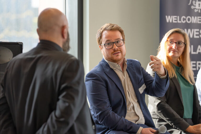 Three people in discussion at a community event