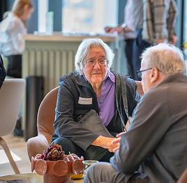 Two people in conversation over coffee