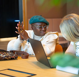Two people working together at a laptop during a session